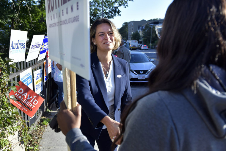 Mayoral candidate city councilor Annissa Essaibi George greets campaigners outside a polling place in the Roxbury neighborhood of Boston on Sept. 14, 2021.