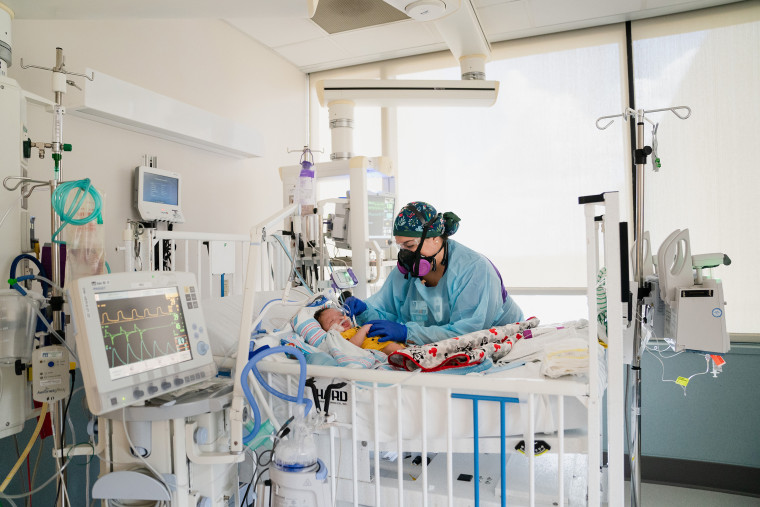 Image: Nurse Sarah Bourgeois tends to Carvase Perrilloux Jr., a two-month-old on a ventilator for respiratory failure due to Covid-19 on the Pediatric Intensive Care Unit at Children's Hospital in New Orleans, on Aug. 18, 2021.