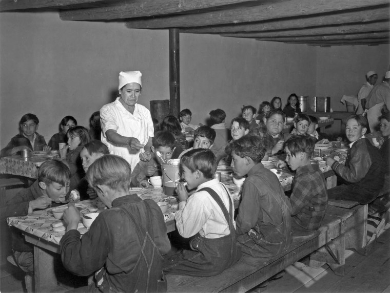 Image: Schoolchildren eat hot school lunches made up primarily of food from the surplus commodities program at a school in Peñasco, N. M. in December 1941.