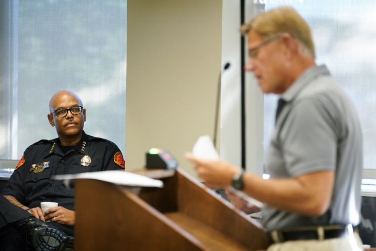Waterloo Police Chief Joel Fitzgerald, left, listens to Cedar Valley Backs the Blue chairman Lynn Moller speak during a city council meeting on Sept. 7, 2021, in Waterloo, Iowa.