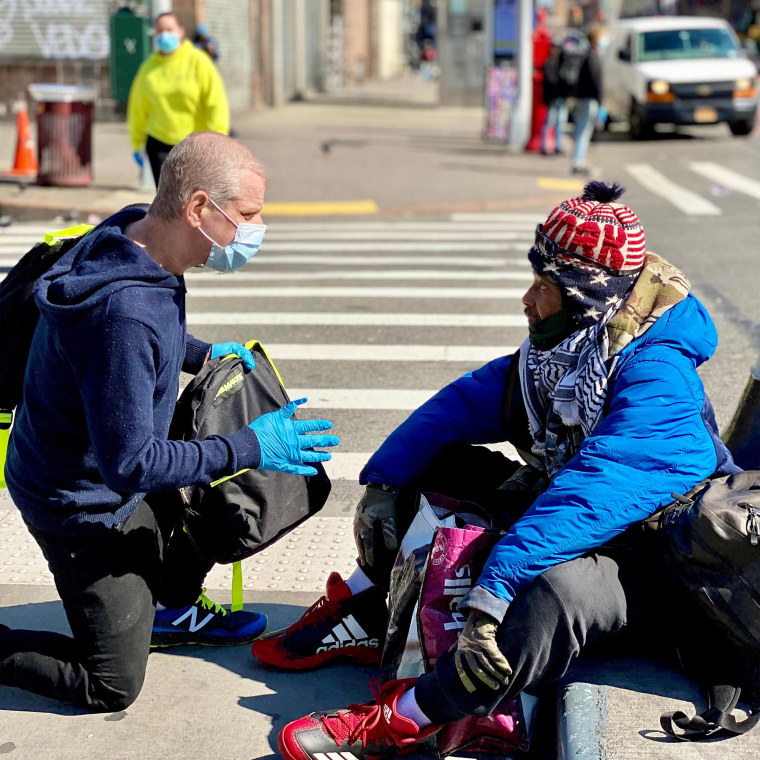 Image: Jeffrey Newman hands out a backpack.