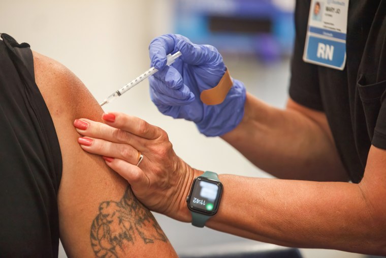 Image: A man receives the Coronavirus (COVID-19) vaccine from