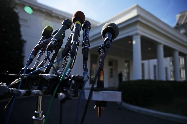 Microphones belong to different media outlets are set up on a stand in front of the West Wing of the White House on Jan. 31, 2017.