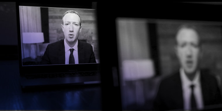 Image: Two screens lined up showing Mark Zuckerberg speaking virtually.