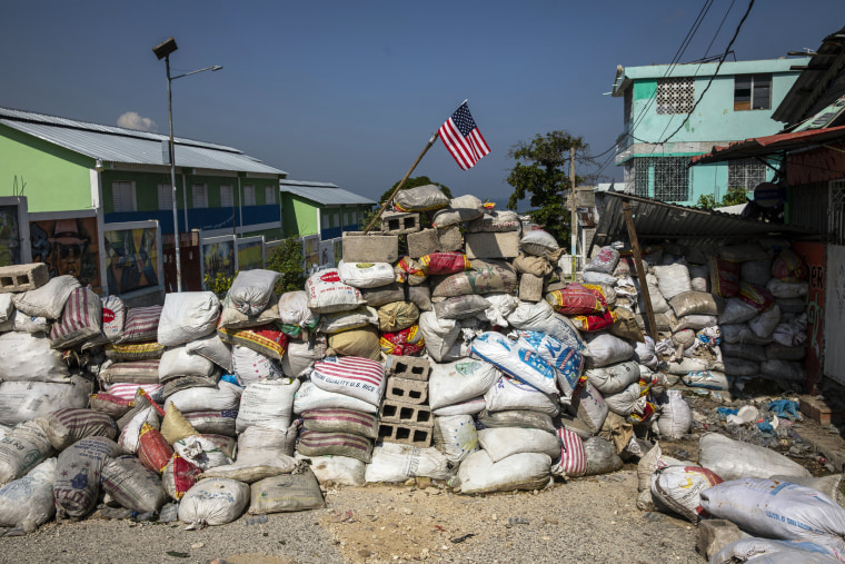 A U.S. national flag tops a barricade delimiting territorial gang control in the Bel Air neighborhood of Port-au-Prince, Haiti, on Sept. 25, 2021.