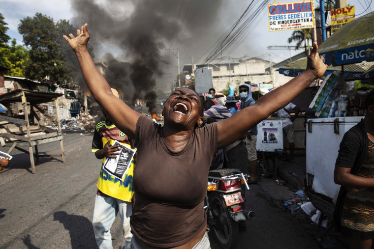 A woman shouts anti-government slogans during a protest organized by friends and relatives of Biana Velizaire, who was kidnapped and held for several days by gang members, in Port-au-Prince, Haiti, on Sept. 27, 2021.