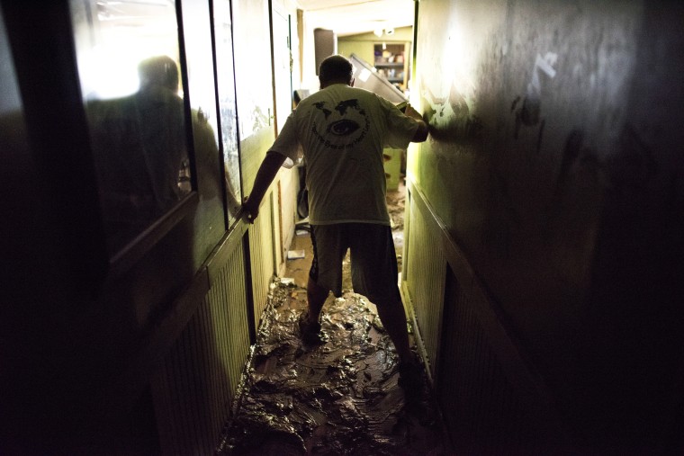 Larry Brooks walks down the hallway of his trailer on a mud covered floor which was destroyed by flood waters on June 25, 2016, in Elkview, W.Va. Brooks said he lost about 95 percent of the personal belongings in his home. The flooding of the Elk River claimed the lives of at least 23 people in West Virginia.