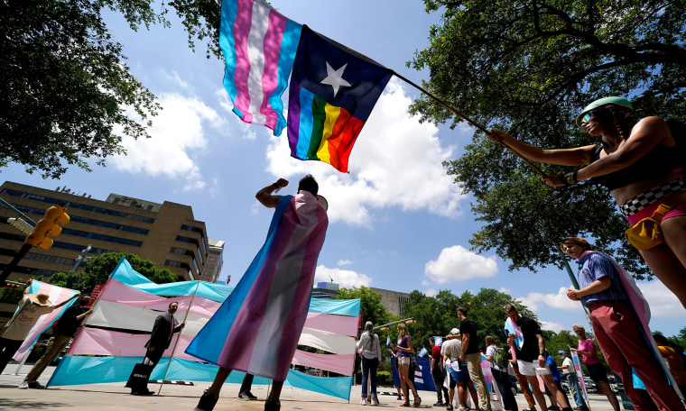 Image: Demonstrators waving the  pride flag.