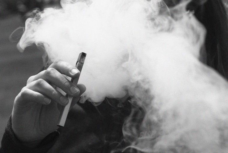 Image: A teen vapes from a Juul e-cigarette  in Oakland, Calif.  May 16, 2018.