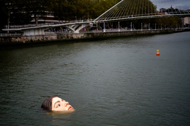 A fibreglass sculpture entitled 'Bihar' is submerged in the Nervion river in Bilbao