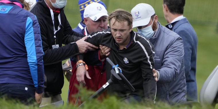 Actor Tom Felton is helped after collapsing on the 18th hole during a practice day at the Ryder Cup at the Whistling Straits Golf Course Thursday, Sept. 23, 2021, in Sheboygan, Wis.