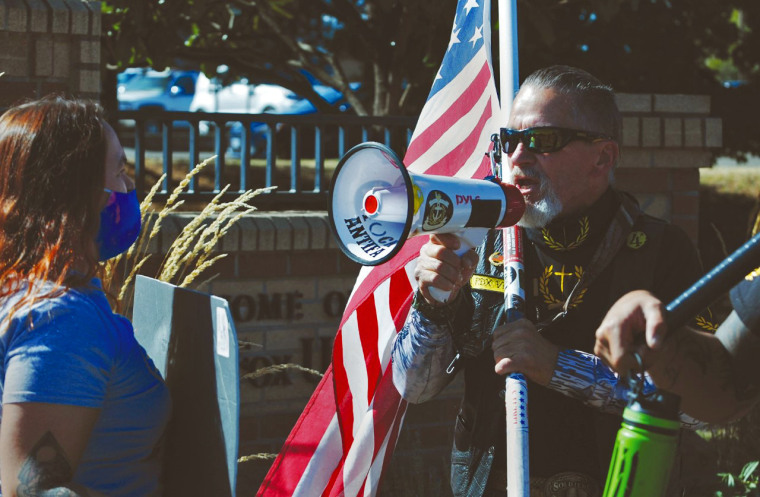 Chelsea Shotts, a Newberg School District behavioral interventionist, faces off with a counterprotester at a demonstration over pride and Black Lives Matter flags last week in Newberg, Ore.