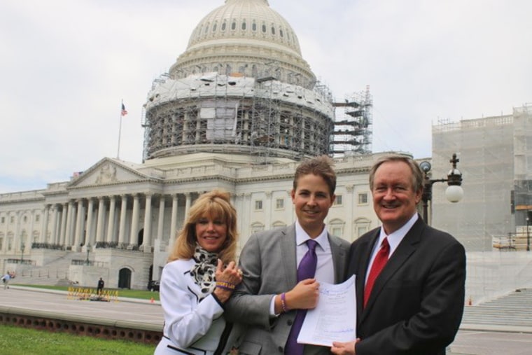 Charlie Smith, the co-founder of the Trevor's Trek Foundation, with her son, Trevor Schaefer, and Sen. Mike Crapo, R-Idaho, with the signed bill in 2016.
