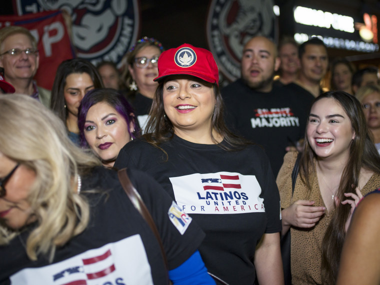 Jen Salinas, vice president of Latinos 4 Trump, takes photos with the group's supporters after a meetup in San Antonio on May 14.