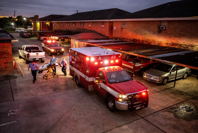 Houston Fire Department paramedics prepare to transport a Covid-19 positive woman to a hospital on Sept. 15, 2021 in Houston, Texas.