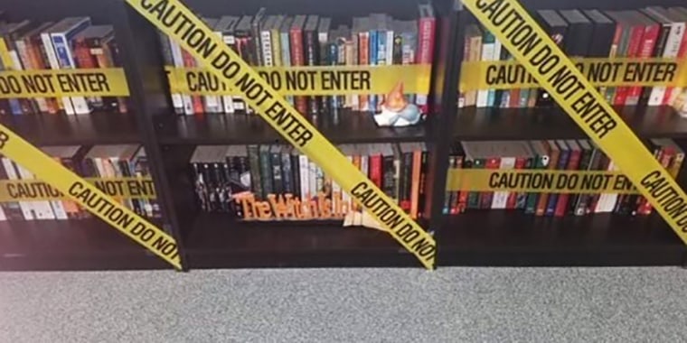 Image:  A Carroll ISD teacher hung caution tape in front of the books in a classroom after the new policy was circulated.