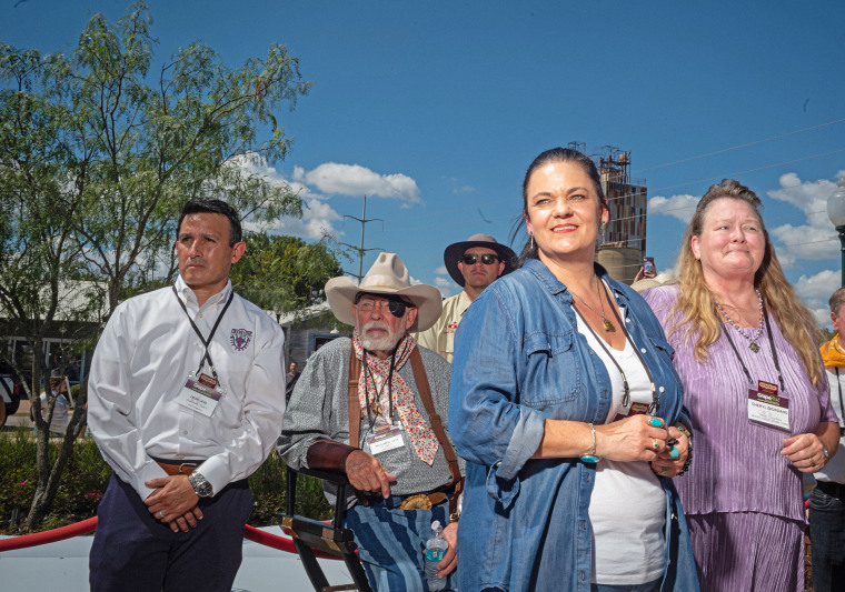 Members of the Mount Tabor Indian community, Tribal Chairman Cheryl Giordano, right, and Community Coordinator Amy Betts watch with Mayor Mayor William Tate, in cowboy hat, as the "Peace Circle" statues are unveiled in Grapevine, Texas, on Sept. 18, 2021.