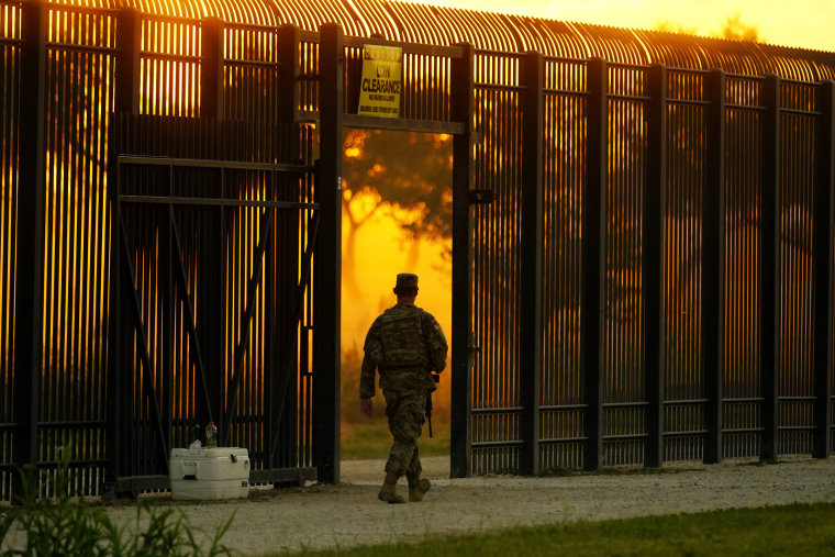 A National Guardsman stands guard at a fence that runs along the Rio Grande near the International bridge on Sept. 17, 2021, in Del Rio, Texas.