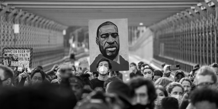 Marchers cross the Brooklyn Bridge demanding police reform on the anniversary of George Floyd's death on May 25, 2021, in New York City. 