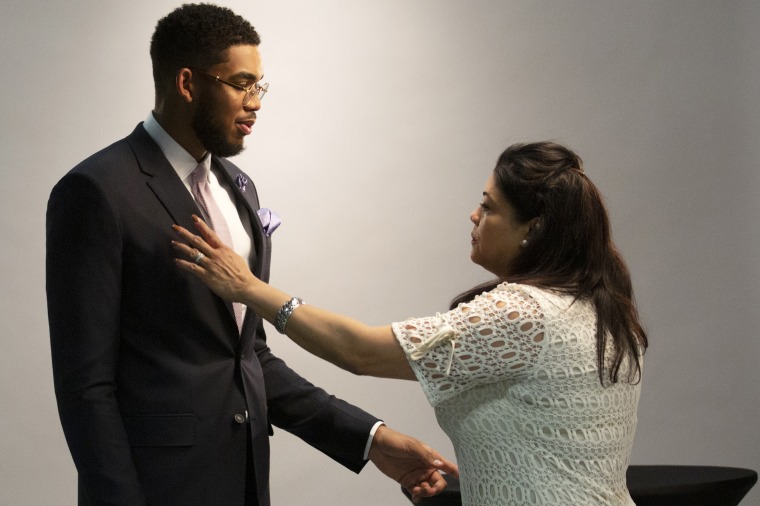 Jacqueline Cruz makes sure her son Karl-Anthony Towns looks good for his official team pictures after being named NBA Rookie of the Year in 2016.