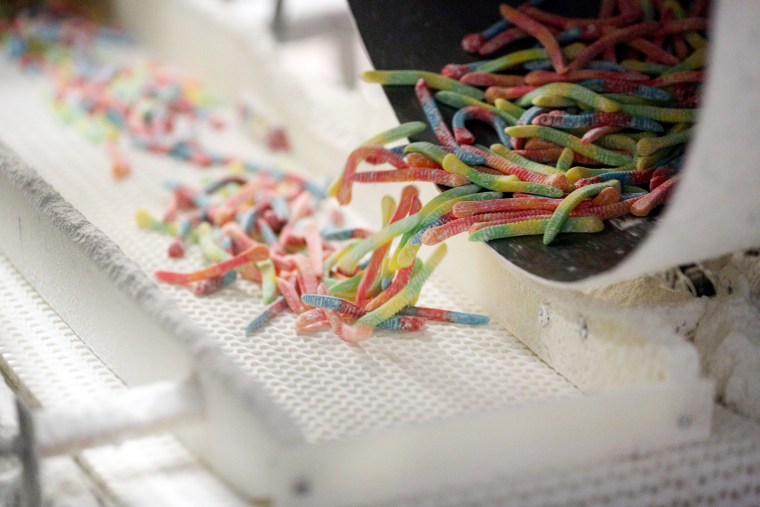 Sour gummy worm candy moves along the production line at the Ferrara Candy Co. facility in Forest Park, Ill., on Oct. 7, 2015.