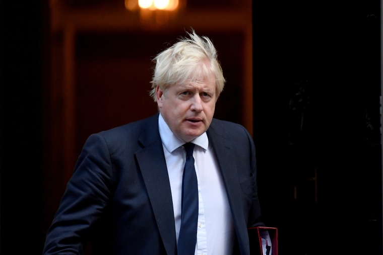 Britain's PM Johnson walks outside Downing Street in London