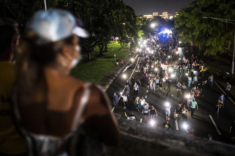 Image: People march along Las Americas Highway to protest the LUMA Energy company in San Juan, Puerto Rico on Oct. 15, 2021.
