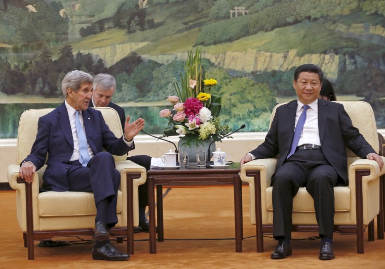 U.S. Secretary of State John Kerry talks with Chinese President Xi Jinping at the Great Hall of the People in Beijing