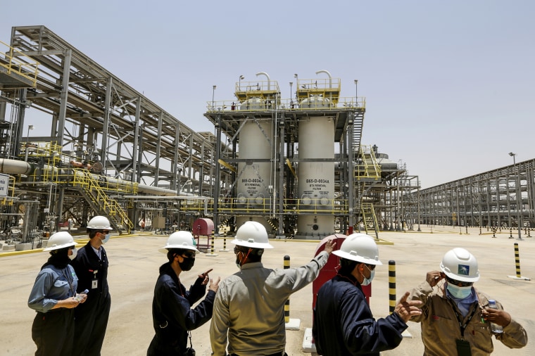 Saudi Aramco engineers and journalists look at the Hawiyah Natural Gas Liquids Recovery Plant in Hawiyah, in the Eastern Province of Saudi Arabia, on June 28, 2021