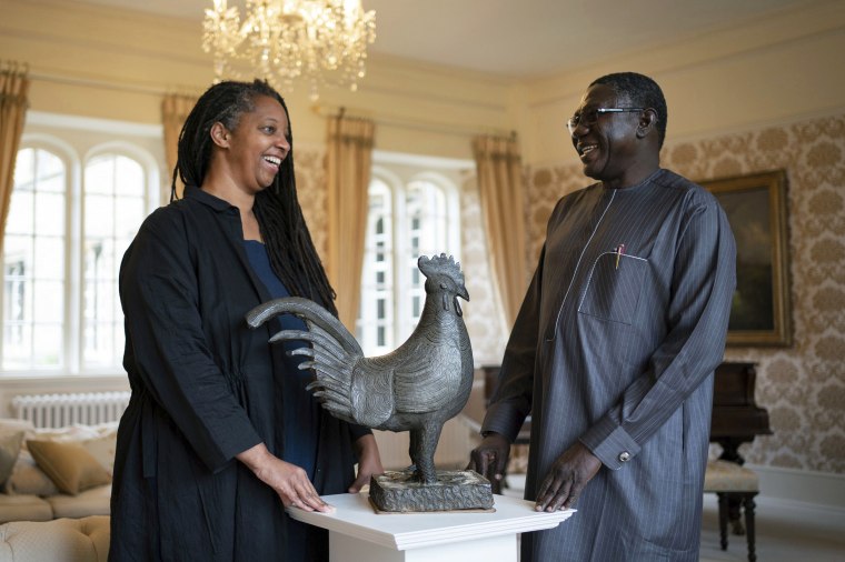 Master of Jesus College Sonita Alleyne with Abba Isa Tijani of Nigeria’s National Commission for Museums and Monuments before the handover of the looted bronze cockerel, known as the Okukur.