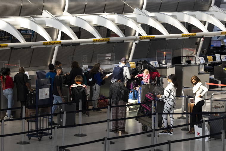 Image: Travelers check-in at an Air France counter at John F. Kennedy International Airport in New York,  on Sept 27, 2021.