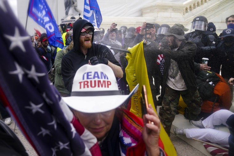 Image: Members of a pro-Trump mob try to break through a police barrier at the Capitol on Jan. 6, 2021.