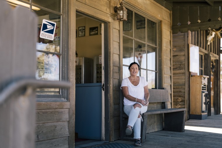 Laurie McVay, who runs the Pioneertown community Facebook page, in front of the Pioneertown Post Office. McVay moved to the Morongo Valley 15 years ago from Boston where she was a financial advisor. She says that “growth is bringing in a lot of money to a town that really needs the money.”