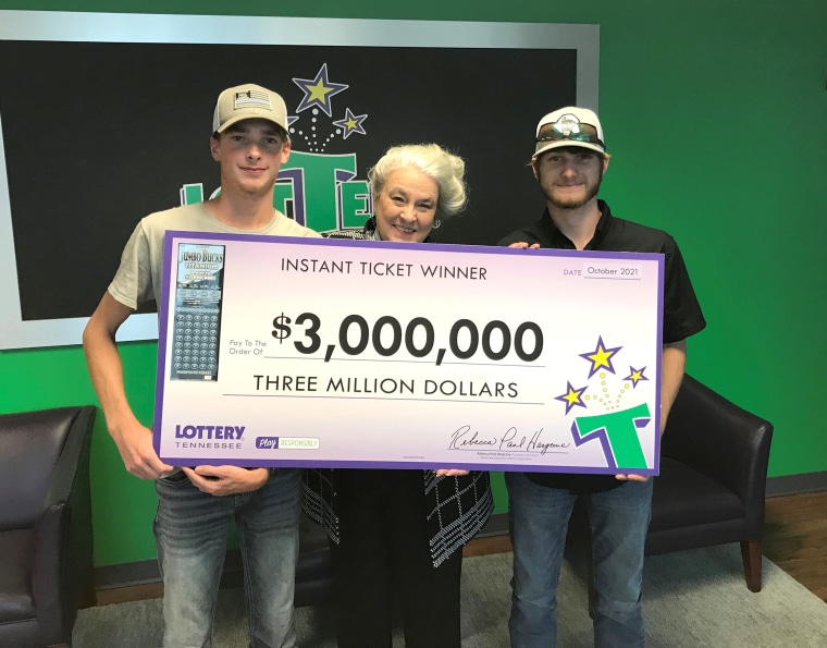 Winner Wyatt Close, Tennessee Lottery President and CEO Rebecca Paul Hargrove, and winner Brandon Thompson show off the $3 million check they took home for a $30 scratch-off lottery ticket.