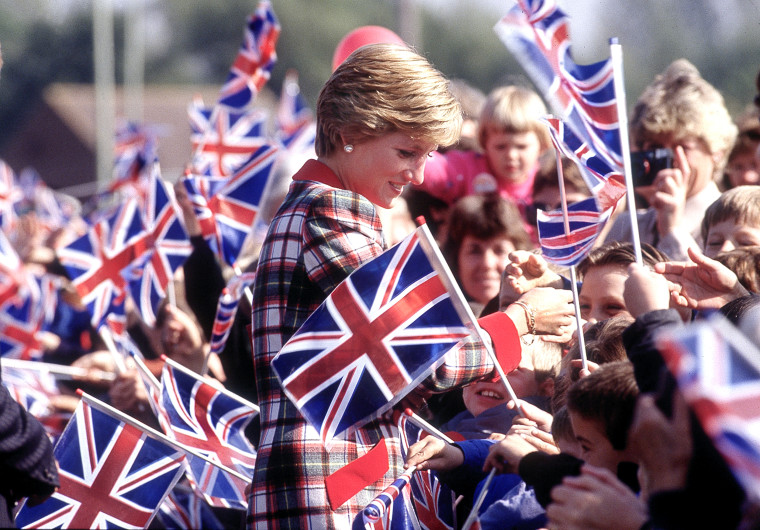 Image: Diana, Princess of Wales walks amongst crowds of children waving flags during her visit to Cullompton in Devon, England, Sept. 1990.