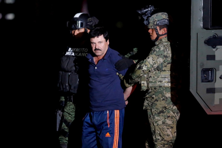 Joaquin "El Chapo" Guzman is escorted by soldiers during a presentation in Mexico City