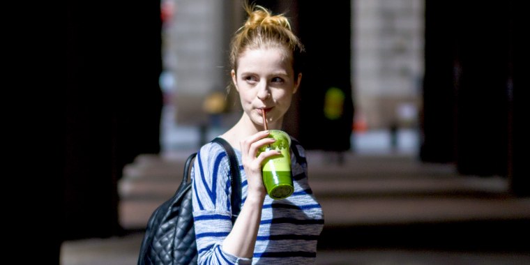 USA, New York City, woman drinking a smoothie in Manhattan