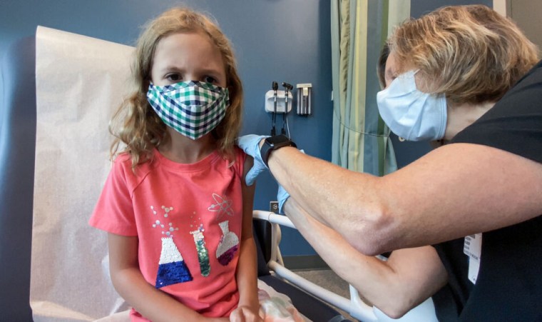 Image: Lydia Melo, 7, gets the first of two Pfizer Covid-19 vaccines during a clinical trial at Duke University in Durham, N.C., on Sept. 28, 2021.