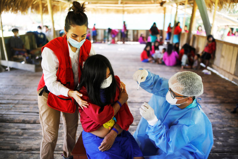 A health workers administers a Covid-19 vaccination in Mangual, Peru, on Oct. 11, 2021.
