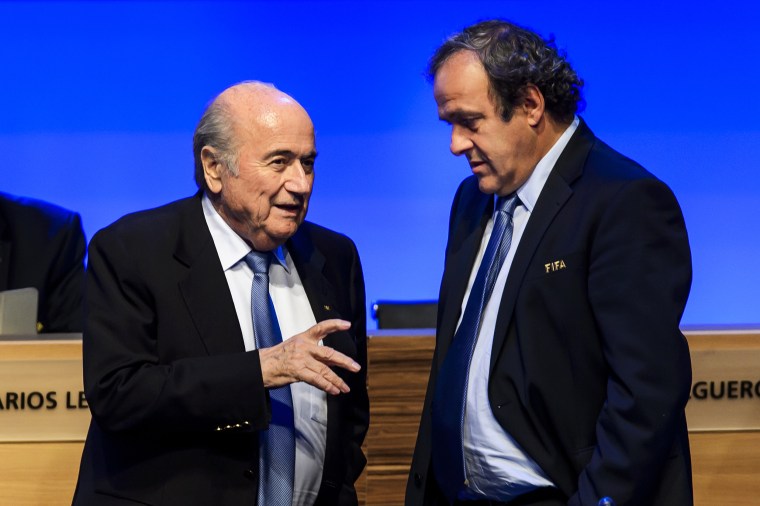 FIFA president Joseph Blatter talks to UEFA president Michel Platini during the 64th FIFA congress on June 11, 2014, in Sao Paulo.