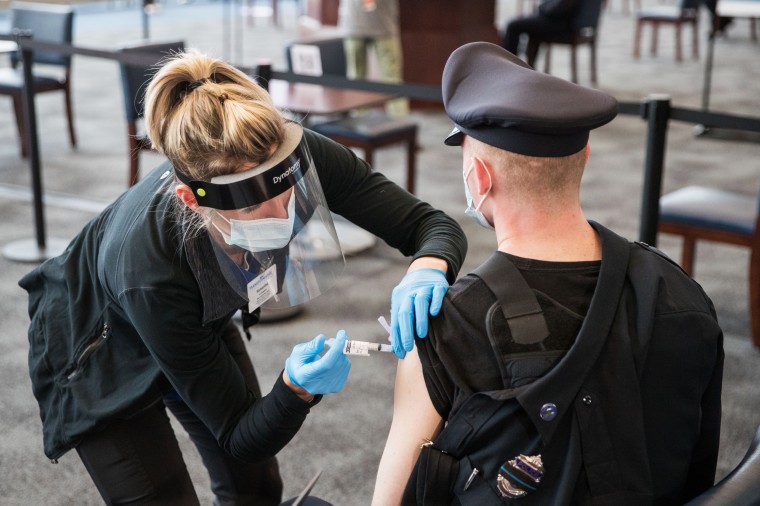 A police officer receives a Covid-19 vaccination Foxborough, Mass., on Jan. 15, 2021.