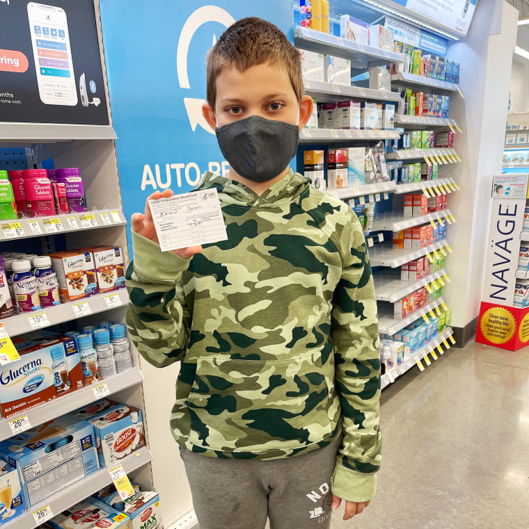 Aaron Eklund, 10, after receiving his first Covid vaccination. 

His date of birth was blurred out from the card by NBC News.
