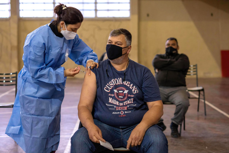 Image: A man gets a shot of Sputnik v vaccine Inside a makeshift