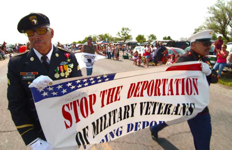 Image: Valente and Manuel Valenzuela march in the July 4 parade in Pueblo, Colo.