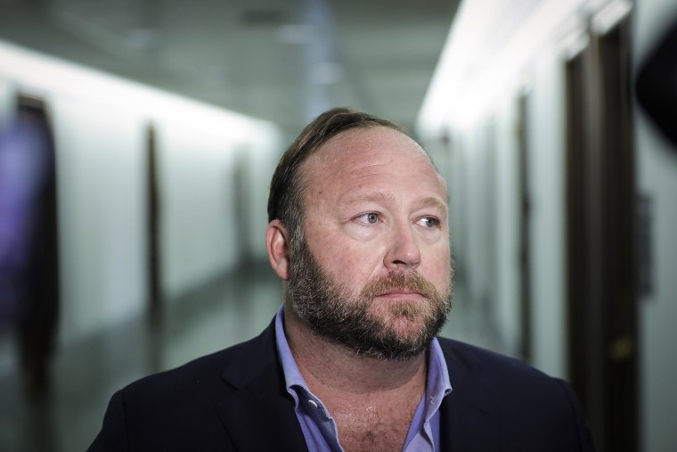Alex Jones of InfoWars talks to reporters outside a Senate Intelligence Committee hearing  on Capitol Hill on Sept. 5, 2018.