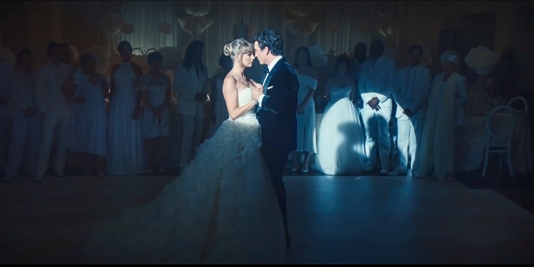 Taylor Swift and Miles Teller in the music video for "I Bet You Think About Me (Taylor's Version) (From The Vault)."