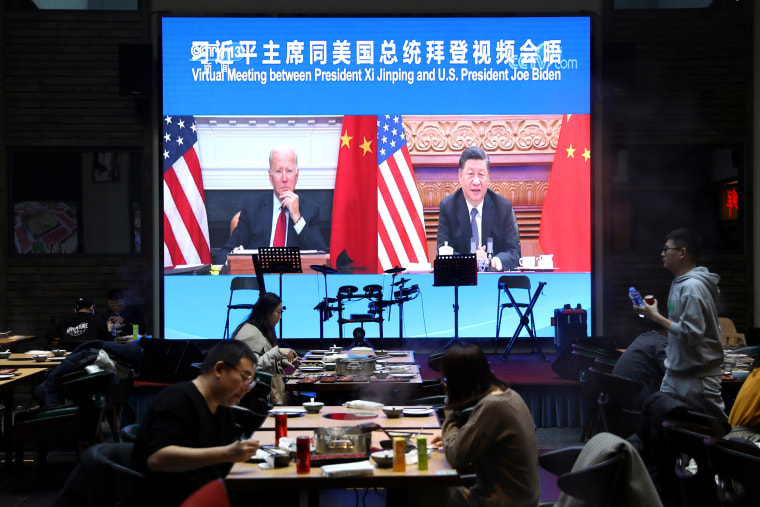 Image: FILE PHOTO: Screen shows Chinese President Xi Jinping attending a virtual meeting with U.S. President Joe Biden via video link, at a restaurant in Beijing