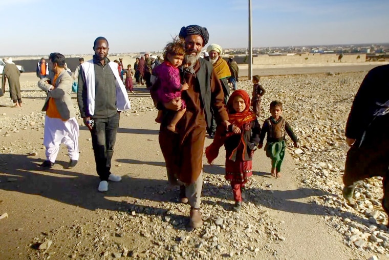 Benazir, 8, second right, walks with a group in Herat, Afghanistan. 