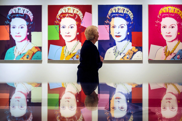 A woman views Queen Elizabeth II by Andy Warhol, 1985, during the press preview of The Queen: Art and Image at the National Portrait Gallery, London on May 16, 2012.