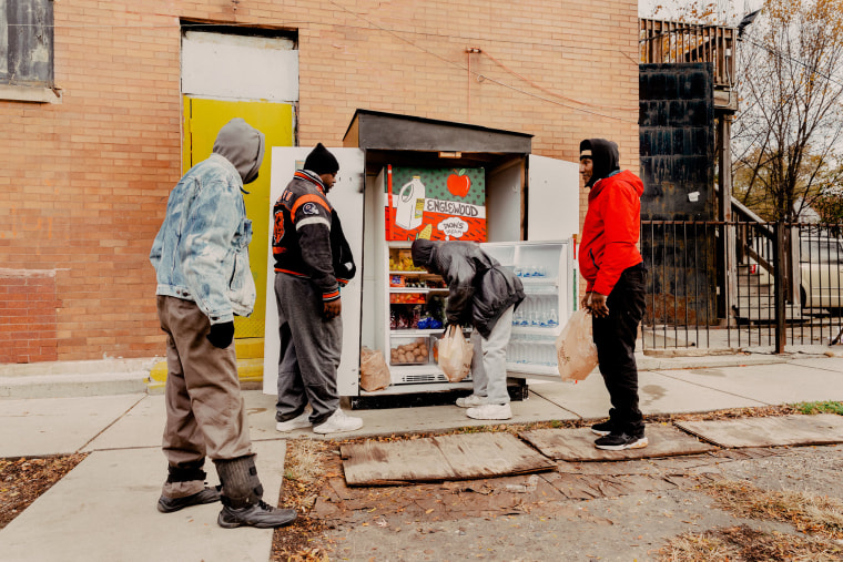 Image: People gather to get free fresh produce from Dion's Dream's fridge in Chicago on Nov. 16, 2021.